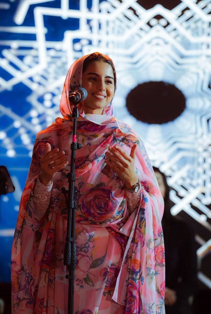 A woman speaking at a microphone